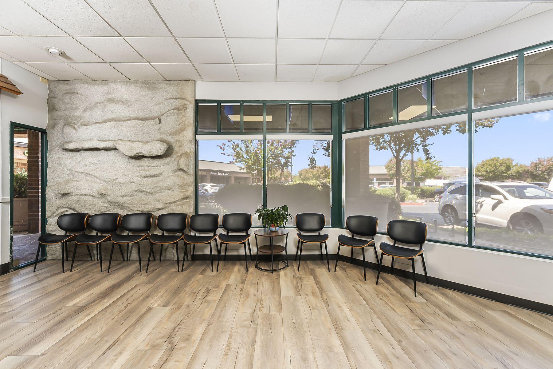 Sunlit waiting room seating along the windows at our Gold River office