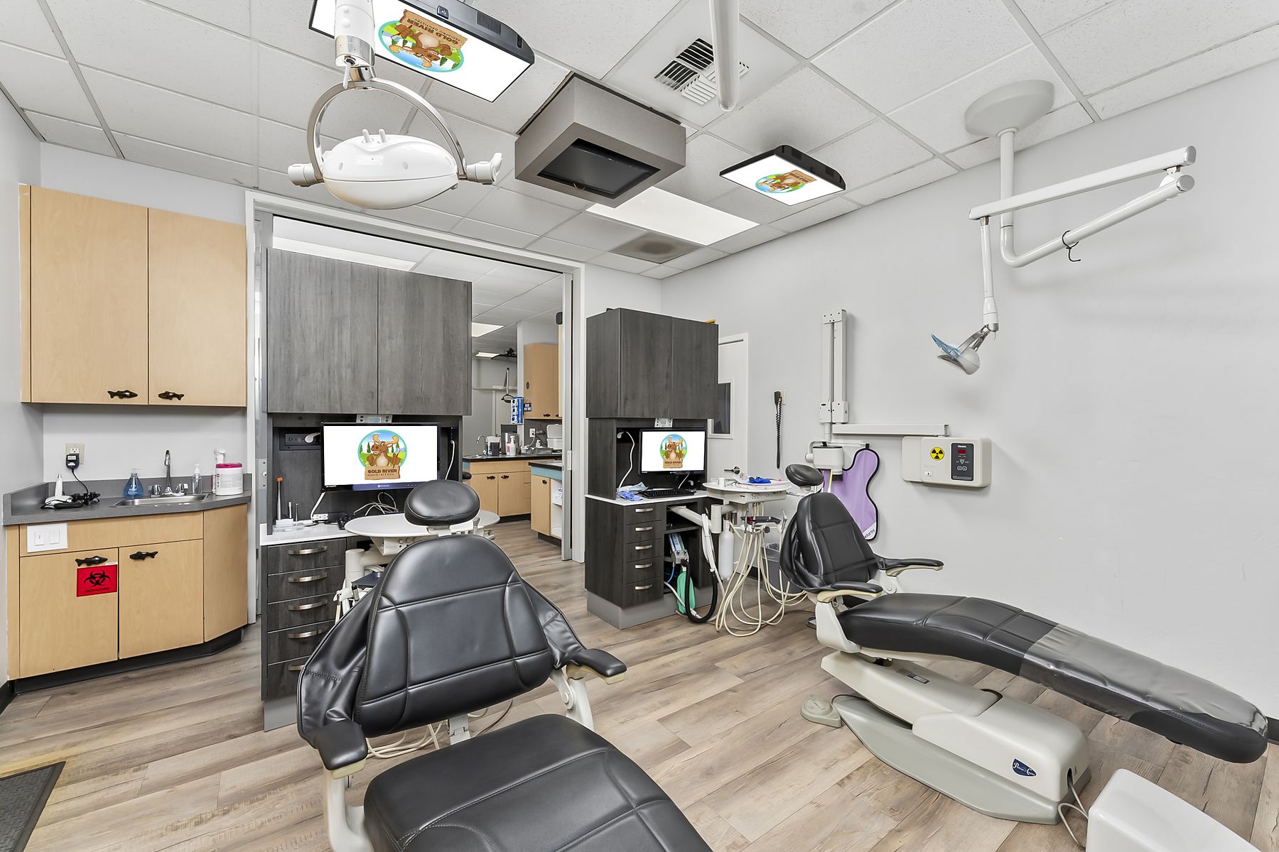 Treatment room with two chairs and a TV mounted above each
